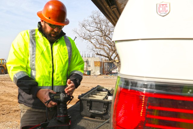 Shane Bevel checks his camera before heading into A Gathering Place For Tulsa. Bevel has spent years documenting the construction of the park. DYLAN GOFORTH/The Frontier